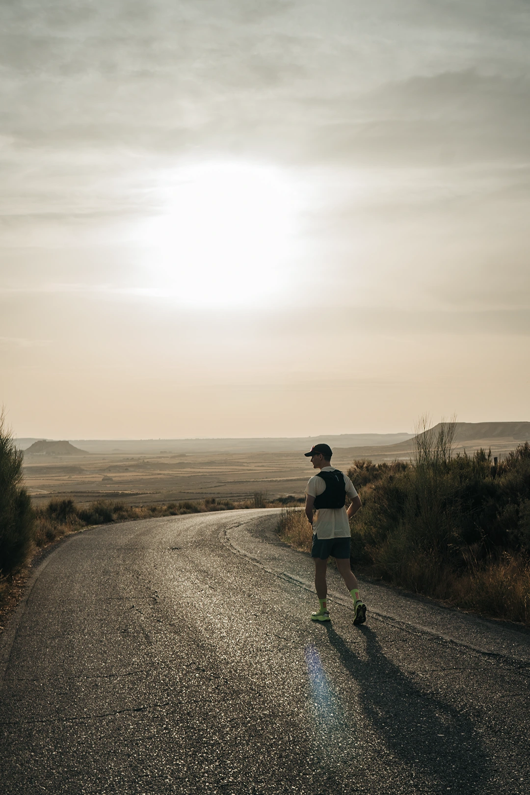 A runner on an open coastal road at sunset
